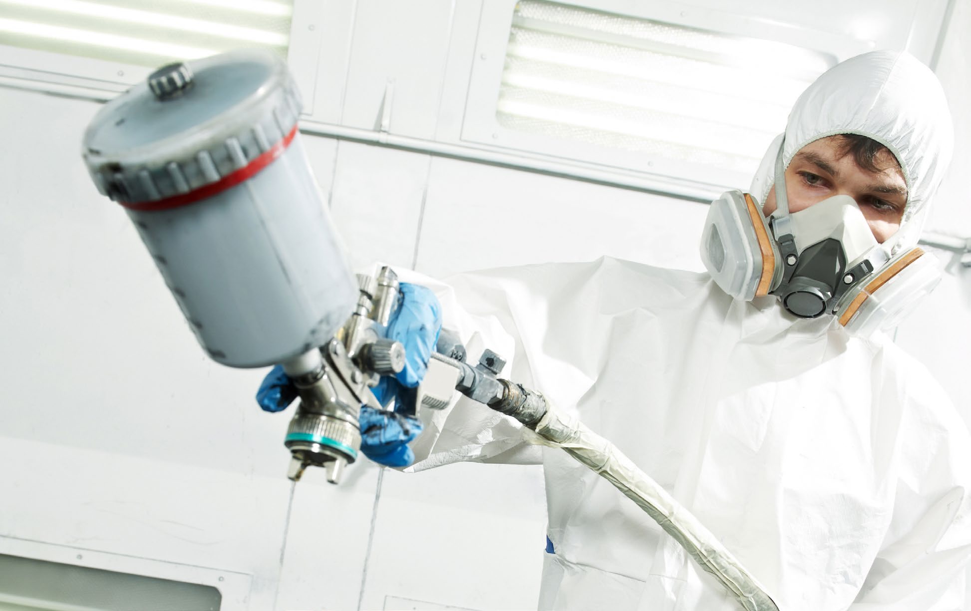 Technician spraying in booth