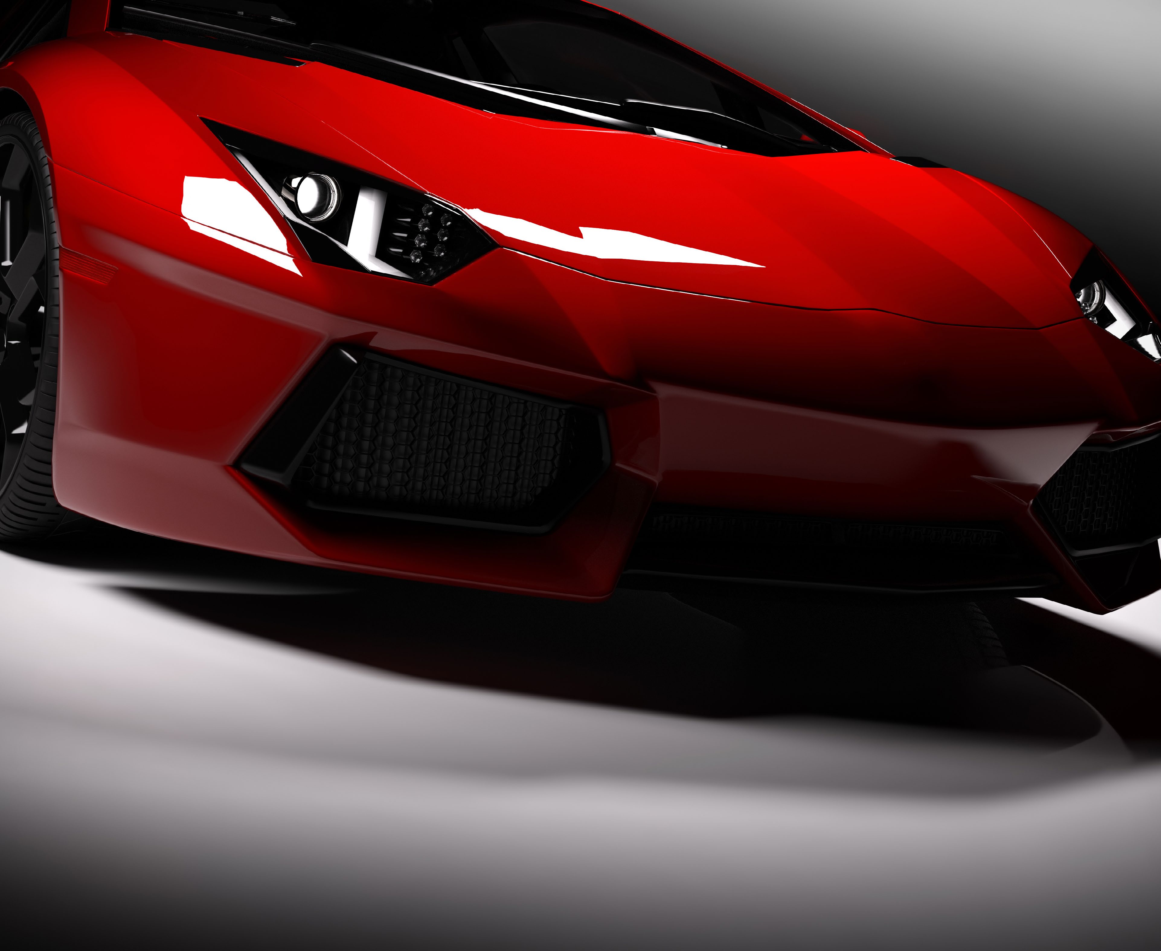 Close-up of a red sports car headlight and bumper
