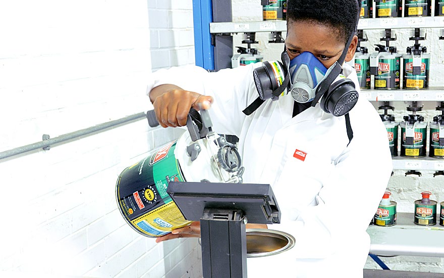 Technician spraying an ARC colour swatch card