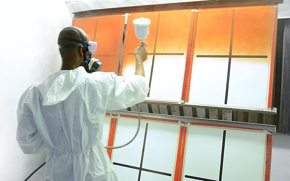 Technician spray-testing an ARC colour panel